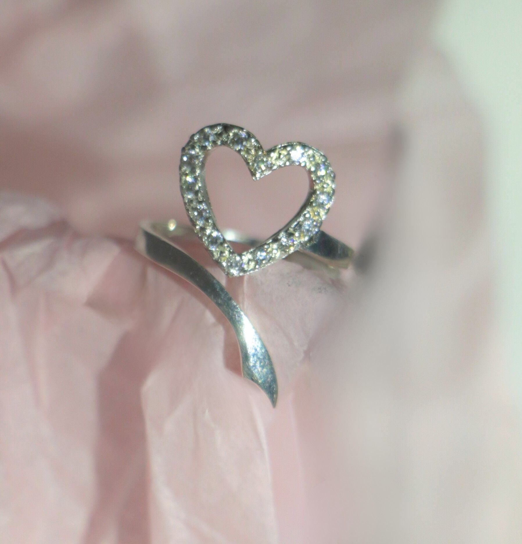Heart-shaped ring with sparkling stones 